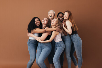 six laughing women of a different race, age, and figure type. group of multiracial females having fu