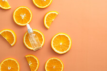 Vitamin C Serum Extract With Sliced Orange Top View. Natural Skin Care Cosmetics.