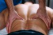© Microgen - Discus Hernia Manual Massage Treatment. Physical Therapist Massaging Lower Back.