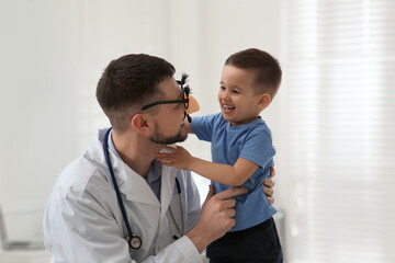 Sticker - Pediatrician playing with little boy at hospital