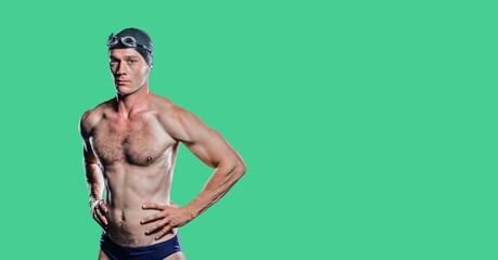 Wall Mural - Composition of male swimmer with copy space isolated on green background