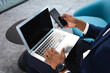 © Wavebreak Media - Mid section of african american businessman using laptop and smartphone at modern office