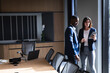 © Wavebreak Media - Diverse businessman and businesswoman discussing over digital tablet in meeting room at office