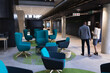 © Wavebreak Media - Diverse businessman and businesswoman discussing over digital tablet at modern office