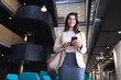© Wavebreak Media - Caucasian businesswoman smiling while using smartphone while standing at modern office
