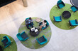 © Wavebreak Media - Overhead view of diverse businessman and businesswoman discussing together at modern office