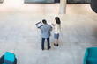 © Wavebreak Media - Overhead view of diverse businessman and businesswoman discussing together at modern office