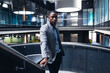 © Wavebreak Media - Portrait of african american businessman standing on the stairs at modern office