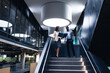 © Wavebreak Media - Diverse businessman and businesswoman discussing together standing on the stairs at office