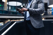© Wavebreak Media - Mid section of african american businessman using smartphone standing near the stairs at office