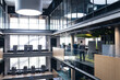 © Wavebreak Media - Diverse businessman and businesswoman talking to each other standing in the corridor at office