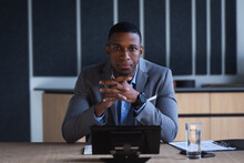 Portrait Of African American Businessman Sitting In Meeting Room At Modern Office