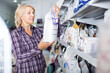 © caftor - woman buying pet food in shop for animal