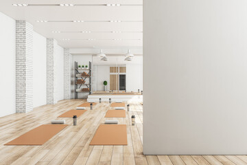 Wall Mural - Modern concrete yoga gym interior with equipment, blank mockup space on wall, daylight and wooden flooring. Healthy lifestyle concept. Mock up, 3D Rendering.