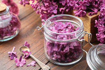Wall Mural - lilac flowers in a jar, oil or infusion bottle, bunch of syringa flowers. the preparation of infusio