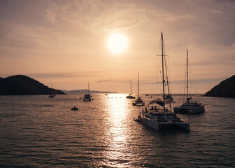 Wall Mural - Aerial view of Luxury yachts sailing in tropical sea at sunset