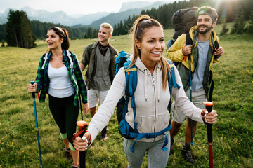Wall Mural - friends hiking together outdoors exploring the wilderness