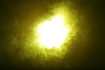 Poster - Artificial magic yellow light illuminates smoke on dark background