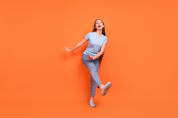 Poster - Full body photo of young cheerful girl happy positive smile have fun excited dance party isolated over orange color background