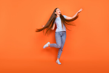 Sticker - Full body photo of lovely young long hairdo lady dance wear blue t-shirt jeans isolated on orange color background