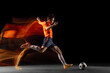 © master1305 - Young caucasian male football or soccer player kicking ball for the goal in mixed light on dark background. Concept of healthy lifestyle, professional sport, hobby.