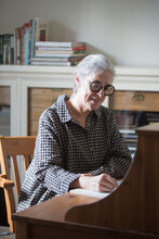 Senior Woman Writing At Home Office
