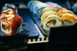 © Inuk Studio/Stocksy - black trays with flavored shushi