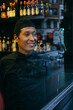 © Inuk Studio/Stocksy - Asian chef smiling looking out the window in Bilbao