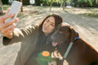 © Valentina Barreto/Stocksy - asian woman and her labrador dog taking a selfie