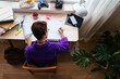 © BONNINSTUDIO/Stocksy - Focused teen studying at desktop in personal room
