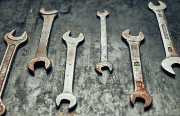 Spanners on steel surface. Old rusty wrenches for maintenance. Mechanic hardware tools to fix. Technical tools background