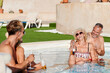 © Ivan Gener/Stocksy - Laughing seniors relaxing in a swimming pool