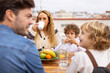 © VICTOR TORRES/Stocksy - Happy family having breakfast on terrace