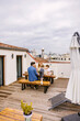 © VICTOR TORRES/Stocksy - Happy family having breakfast on terrace