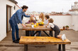 © VICTOR TORRES/Stocksy - Content family having breakfast together on terrace