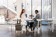 © BONNINSTUDIO/Stocksy - Multiracial coworkers looking at camera during work