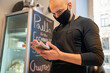 © Hernandez & Sorokina/Stocksy - Man With Face Mask Holding Smartphone