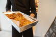 © Hernandez & Sorokina/Stocksy - Chef Holding Tray Filled With Pastry