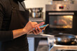 © Hernandez & Sorokina/Stocksy - Chef Holding Smartphone At Kitchen