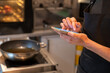 © Hernandez & Sorokina/Stocksy - Man Holding Smartphone At Kitchen