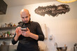 © Hernandez & Sorokina/Stocksy - Chef Holding Smartphone At Kitchen