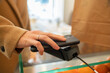 © Hernandez & Sorokina/Stocksy - Payment Using Cellphone Indoors