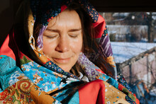A Woman Sits By The Window At Home On A Winter Day.