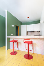Two Red Stools In A Colourful Kitchen Interior Design
