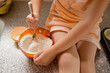 © Jennifer Bogle/Stocksy - Girl stirs flour in bowl