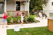 © Jennifer Bogle/Stocksy - Girls play in yard full of bubbles