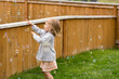 © Jennifer Bogle/Stocksy - Girl plays in yard with bubbles