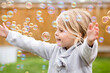 © Jennifer Bogle/Stocksy - Profile of girl surrounded by bubbles
