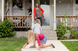 © Jennifer Bogle/Stocksy - Mother and daughters in bubble filled yard