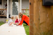 © Jennifer Bogle/Stocksy - Mother and daughters draw with chalk